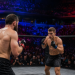 MMA fighters facing off in an octagon inside a packed arena
