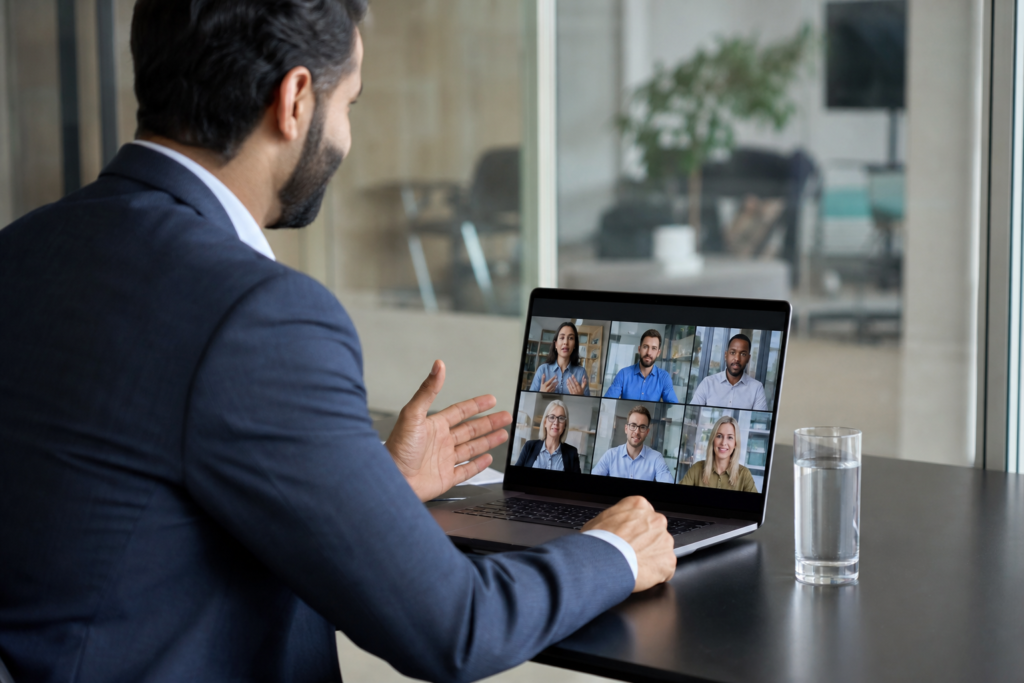 Business professional using a laptop during a video meeting